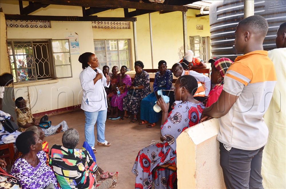  Fridah Nabadda, a clinical officer at Katikamu health center III sensitising hypertension patients during routine clinic on Thursday.