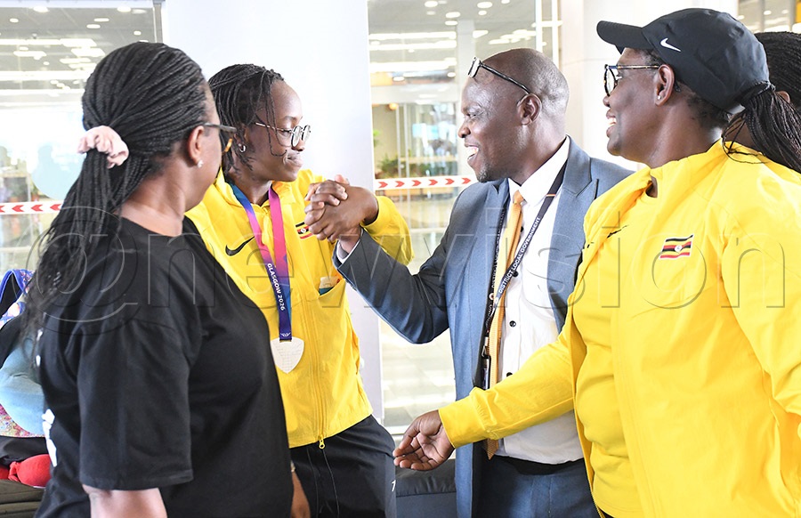 Husnah Kukundakwe (2nd left) and her mum Hashima Mutamuriza (right) are welcome back by UPC's Irene Nabisenke and Innocent Tumwesigye (2nd right) at Entebbe Airport on return from the Commonwealth Games where she won silver in the 100m SB8 breaststroke. Photo by Michael Nsubuga