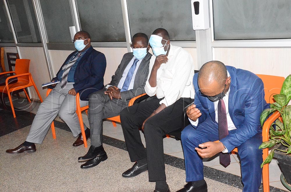 (L-R) OPM registration officer Henry Bwana, OPM commissioner Patrick Okello, Information Technology Head Noel Okwang and Senior Settlement Commandant Geoffrey Mugabe, seated at the IGG office shortly before their arrest by the police. (Credit: Isaac Nuwagaba)