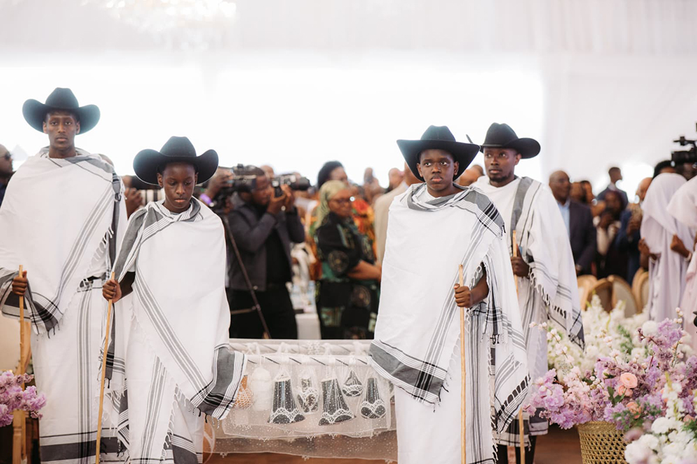 Nsasiirwe&rsquo;s siblings carrying &lsquo;omugamba&rsquo;.