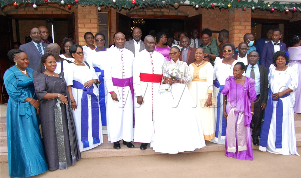 The Kiwanukas share a photo moment with some of their guests after their thanksgiving service at Namirembe Cathedral.