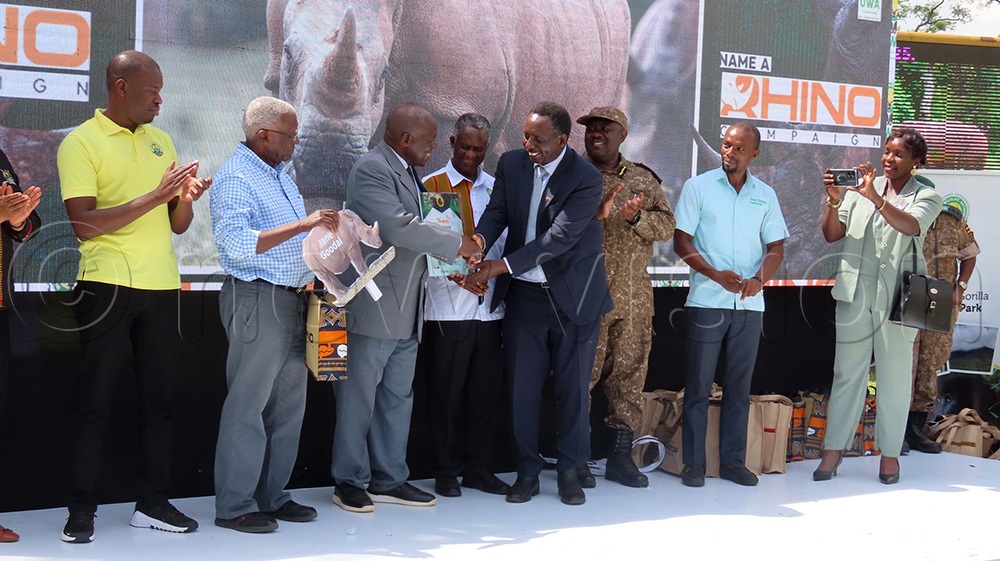 Minister of Tourism Tom Butime and the one of State for Tourism Martin Mugarra hand over a plaque when the Jane Goodall Institute Uganda had a rhino named after her last month at Ziwa Rhino Sanctuary. (Credit: Titus Kakembo) 