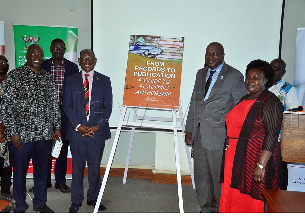 Prof. Magara (Left), Prof. Nawangwe (Second left), Dr Kaddu (First Right), Prof. Oyana (Second Right), discussing during the launch of the book at the Senate Building, Makerere University. Looking on are officials from the university. (Photo by John Odyek)