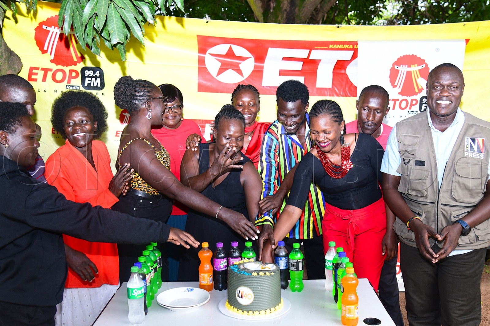 99.4 FM Etop staff cutting cake.