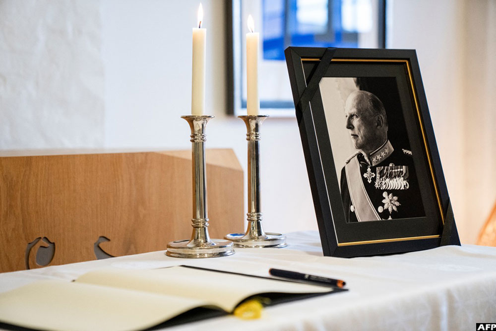 The book of condolences and a photo of King Harald V are seen at the Norwegian Embassy in Nordhavn in Copenhagen.