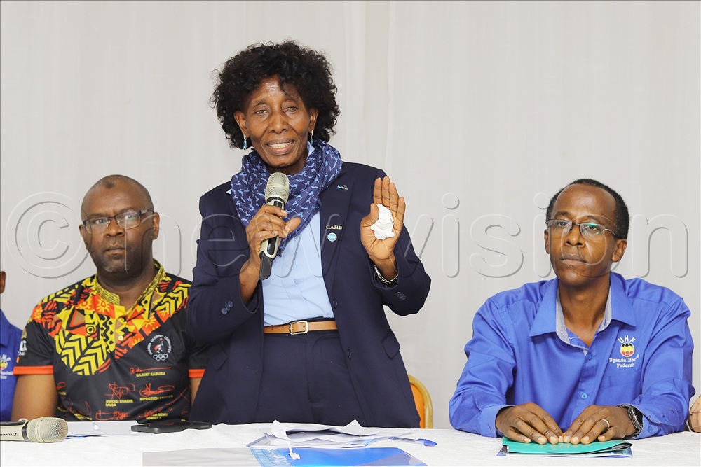 Uganda Handball Federation Outgoing president Shiela Agonzibwa address the AGM before dissolving the Executive at Old Kampala. Looking on (R) Uganda Olympic Committee treasurer Sadik Nasiwu and Uganda Handball outgoing treasurer Daniel Karibwigye at Old Kampala.