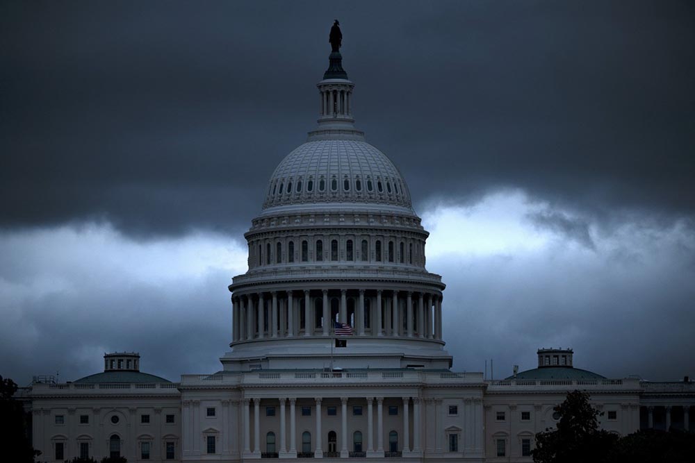 A view of the US Capitol building following rain showers on the eighth day of the federal government shutdown on October 8, 2025, in Washington, DC. President Donald Trump said on October 6 that he would be "happy" to negotiate a deal on health programs with Democrats, but demanded the federal government first be re-opened, as a crippling shutdown entered its second week. (Credit: AFP)