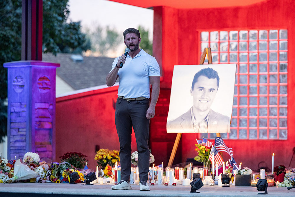 Podcast host Jason Preston speaks to the crowd during a candlelight vigil for youth activist and influencer Charlie Kirk at a makeshift memorial at Orem City Center Park in Orem, Utah, a day after he was shot during a public event at Utah Valley University on September 11, 2025. (Credit: AFP)