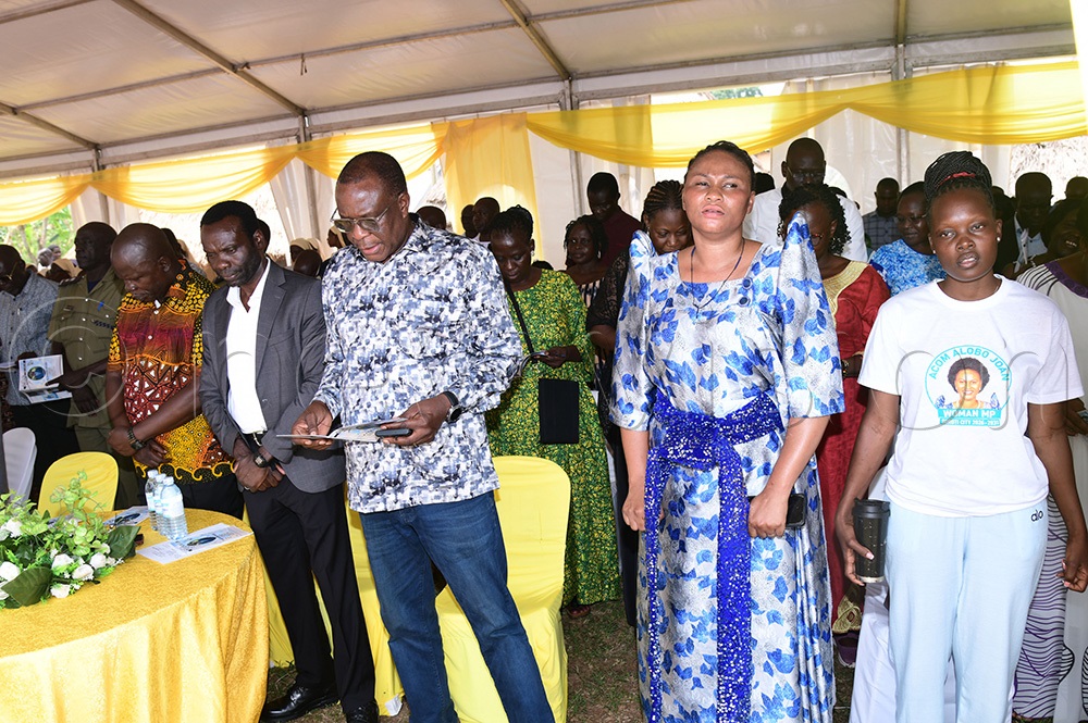 Soroti City woman MP Joan Alobo with MP-elect Dakabela Peter Edeku and David Calvin Echodu and minister Clement Ongalo during the funeral prayers. (Photo by Godfrey Ojore)