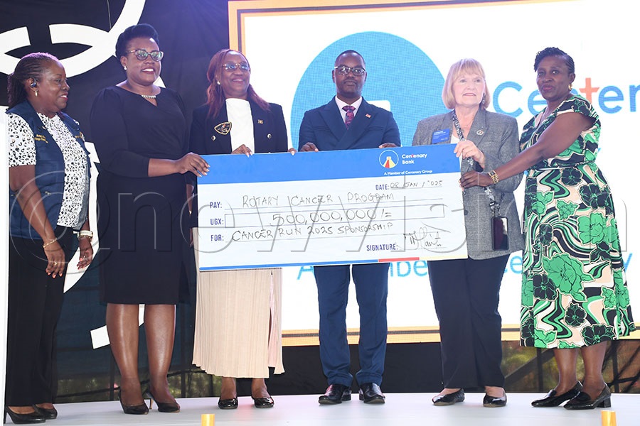 Centenary Bank General Manager, Corporate communications and Marketing Beatrice Lugalambi (2nd left) hands over a sh500m dummy cheque to Rotary International president Stephanie Urchick alongside other Rotarians before she launched the 2025 Cancer Run. Photo by Michael Nsubuga