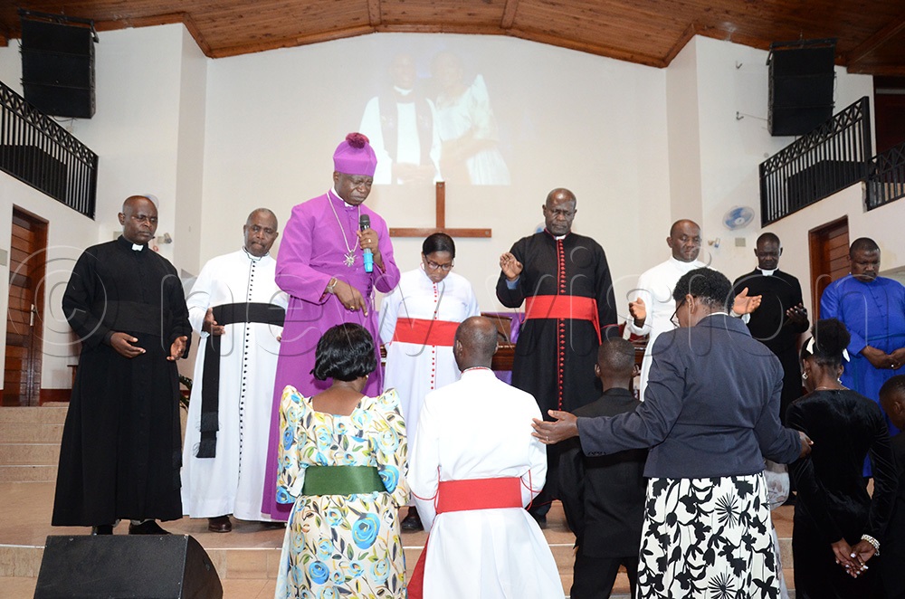 Bishop Onesimus Asiimwe (purple wear) of North Kigezi leading a group of cleargy as the church prayed for Rev. Canon Prof. Grace Lubaale, the fourth Bishop-elect of Busoga Diocese and his family during his farewell and thanksgiving service at the Church of the Resurrection Bugolobi Kampala on December 12, 2025. (Photo by Lawrence Mulondo)