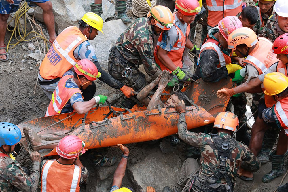 This handout photograph taken and released by the Nepal Army on September 4, 2026 shows army personnel carrying a worker who was trapped inside a tunnel, during a rescue operation at Trishuli-3A Hydropower Project in Nepal's Rasuwa district.