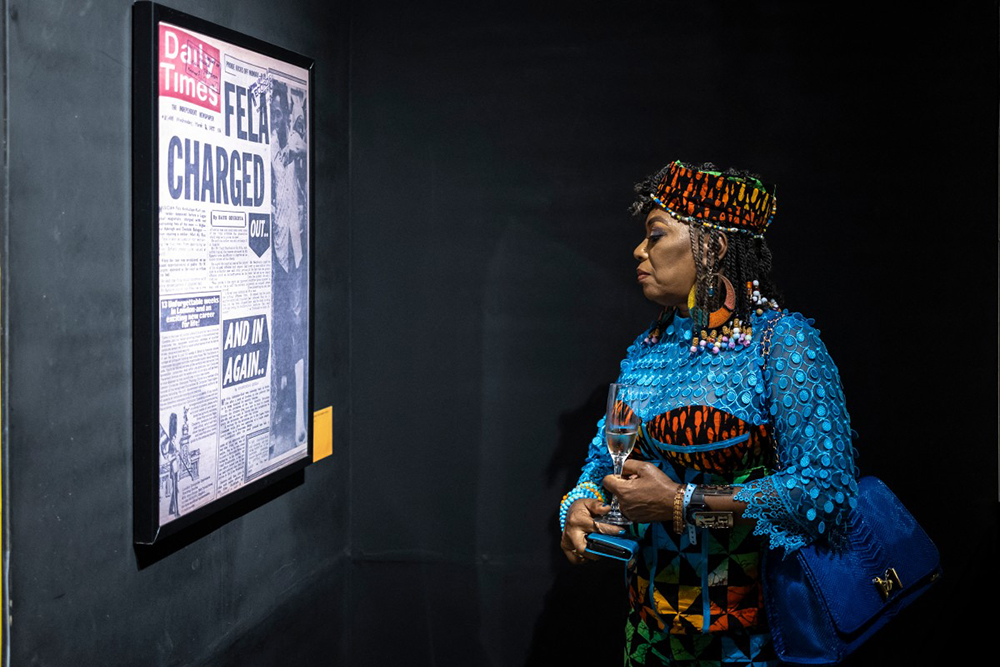 Yeni Kuti, Fela Kuti’s daughter, looks at the framed Daily Times newspaper that displays a headline on Fela Kuti at the Afrobeat Rebellion: Fela Anikulapo Kuti exhibition during the opening night at the Ecobank Pan-African Center in Lagos, on October 12, 2025.
