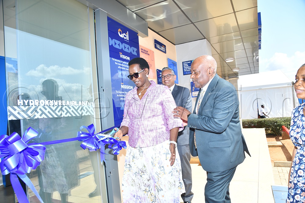 Diana Atwine, Permanent Secretary at the Ministry of Health, cuts the tape as Emmanuel Katongole, Co-founder and Chairman of Quality Chemical Industries Limited, and ceo Ajay Kumar Pal in the back looks on during the launch of the Sikurea Hydroxyurea factory and 500mg capsules for the treatment of sickle cell anemia at QCIL on May 20, 2026. (Photo by Richard Sanya)