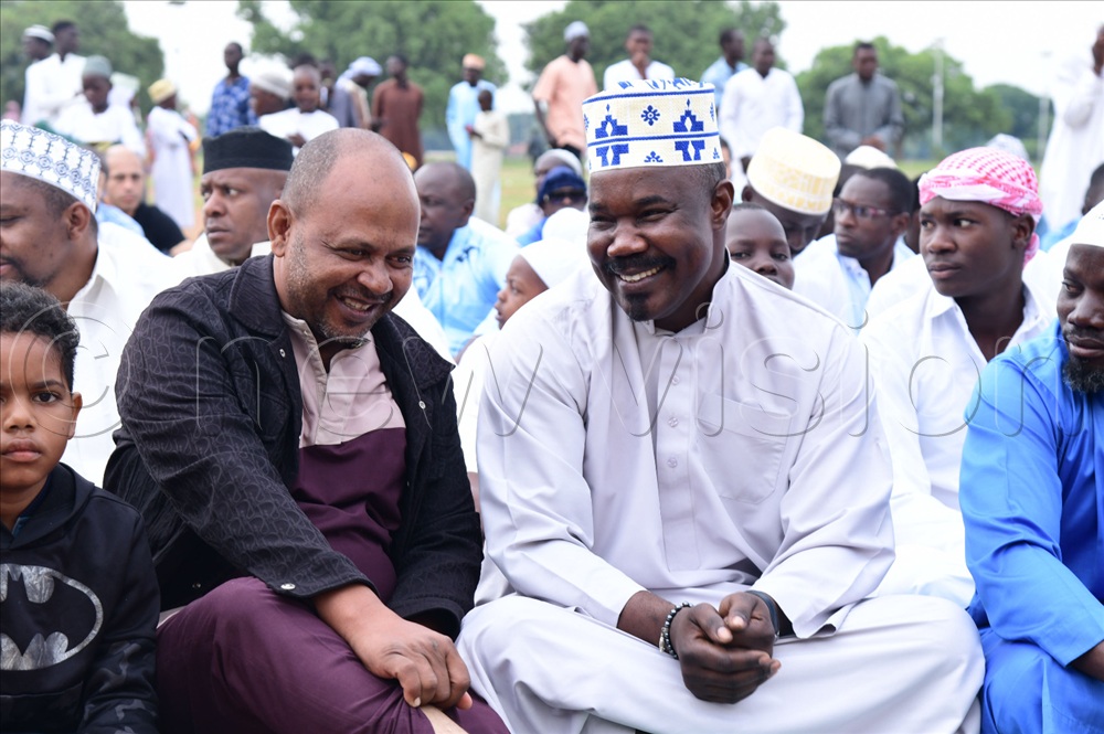 The Soroti East MP-elect Moses Okia Attan (R) sharing a light moment with a fellow Muslim faithful during Eid el-Fitr prayers in Soroti.