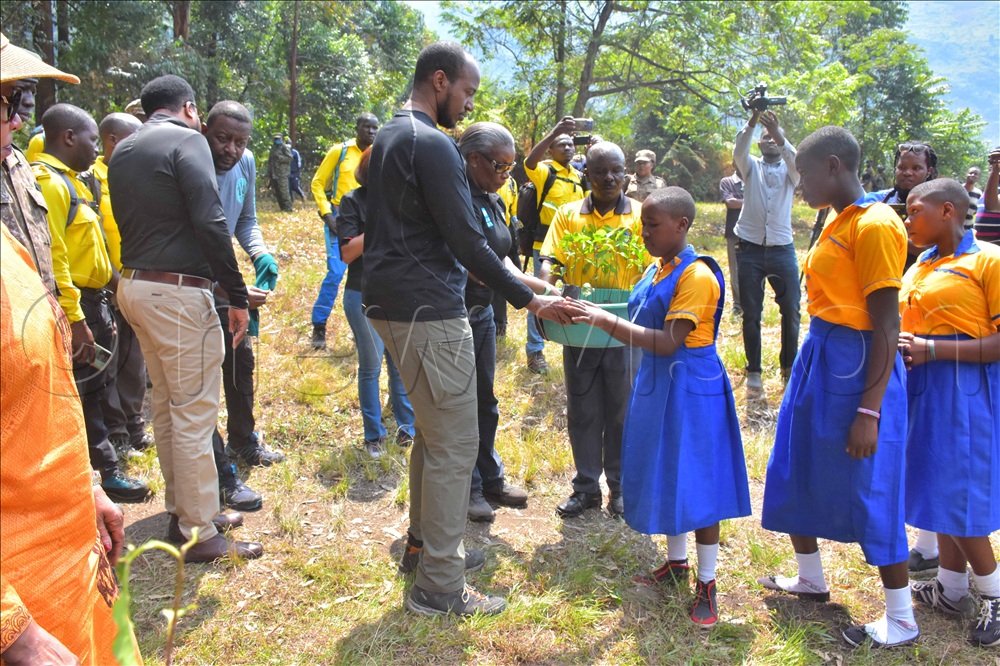 Omukama Oyo giving out tree seedlings to pupils in Kasese district, in a campaign to conserve Rwenzori mountains
