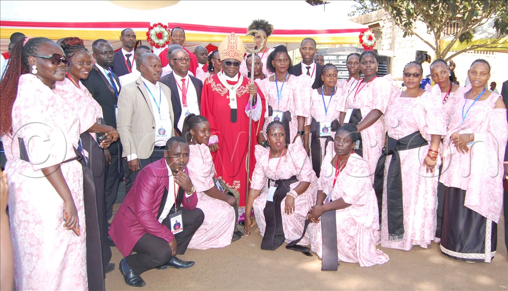Archbishop Paul Ssemogerere (holding a crosier) shares a photo-moment with the staff-members of St. Donozio Ssebuggwawo Boys PS Kisubi during the function.