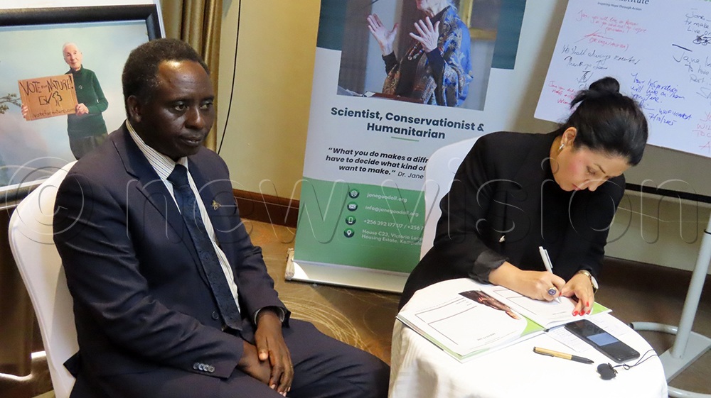 The Ed Jane Goodall Institute Uganda, James Byamukama looks on as Head of Office Austrian Embassy Katja Kershbaumer signs the condolence book of Jane Goodlal at the Sheraton Hotel November 7, 2025. (Credit: Titus Kakembo)