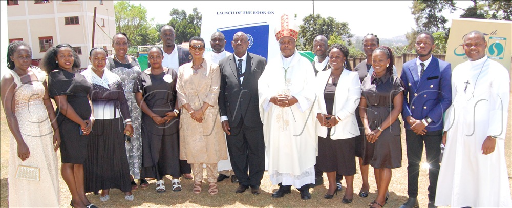 The state minister for health, Hon. Anifa Kawooya (sixth-left,front-row) shares a photo-moment with archbishop Lambert Bainomugisha (wearing a mitre) and the members of staff of Serenity Centre.