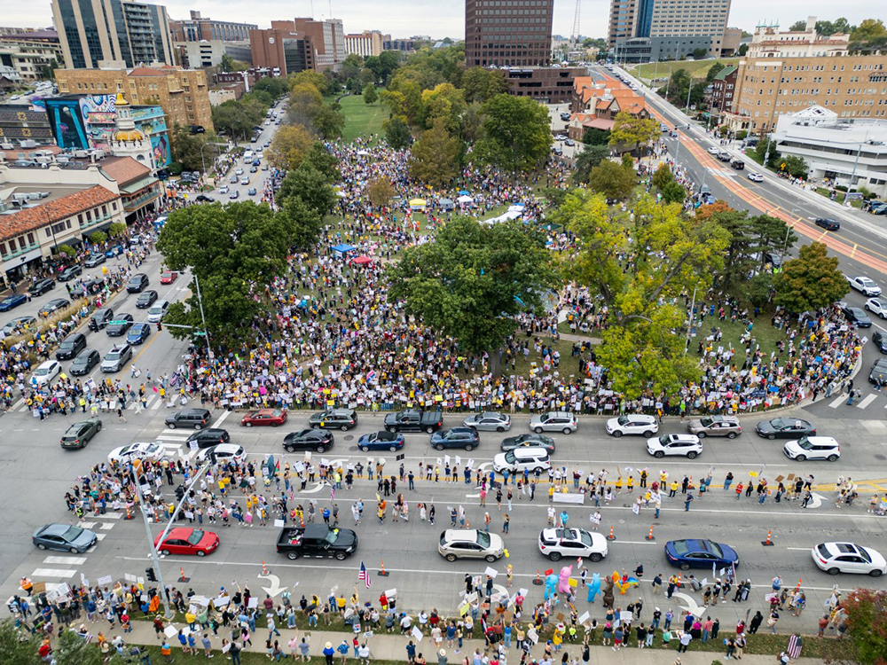Protesters rally during the "No Kings" national day of protest in Kansas City, Missouri on October 18, 2025. From New York to San Francisco, millions of Americans are expected to hit the streets to voice their anger over President Donald Trump's policies at nationwide "No Kings" protests.