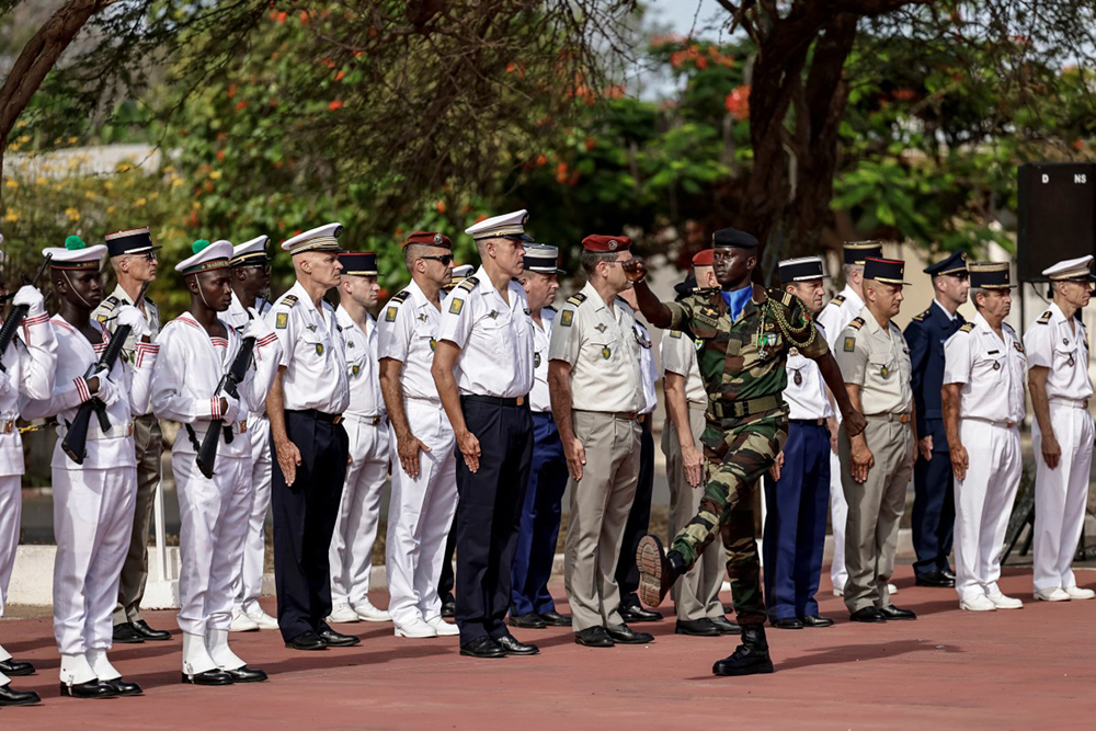 A Senegalese soldier marches past French army staff ahead of a ceremony where France returned Camp Geille, its largest base in the country, and its airfield at Dakar airport, in Dakar on July 17, 2025. the pull-out comes after similar withdrawals across the continent, with former colonies increasingly turning their backs on their former ruler. (AFP Photo)