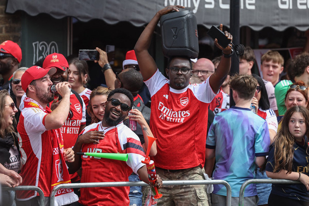 Arsenal supporters wait for the start of a parade along the route to celebrate Arsenal's men team's Premier League title during celebrations outside the Emirates Stadium in London on May 31, 2026. It is the first Premier League title for the North London team since the 2003-04 season. 