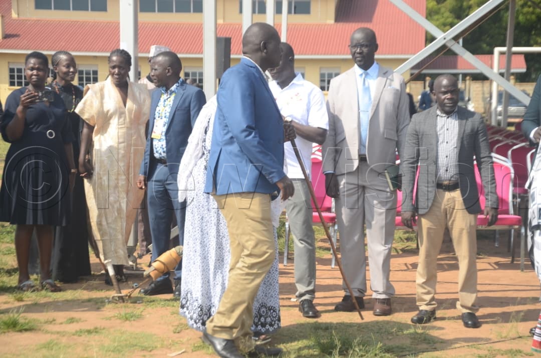 One of Gen. Moses Ali&rsquo;s sons arrives with his mother for the official funeral. (Credit: Adam Gule)