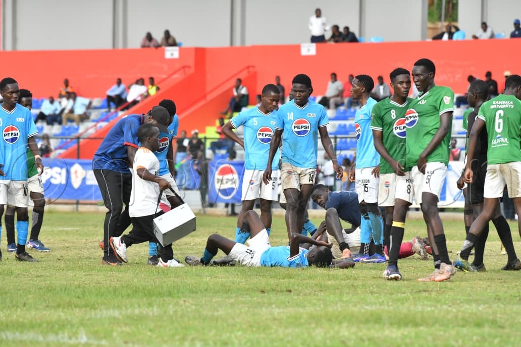Bugema University&rsquo;s star forward Eric Sawa hits the turf after a heavy challenge during their University Football League clash. (Photo by Richard Sanya)