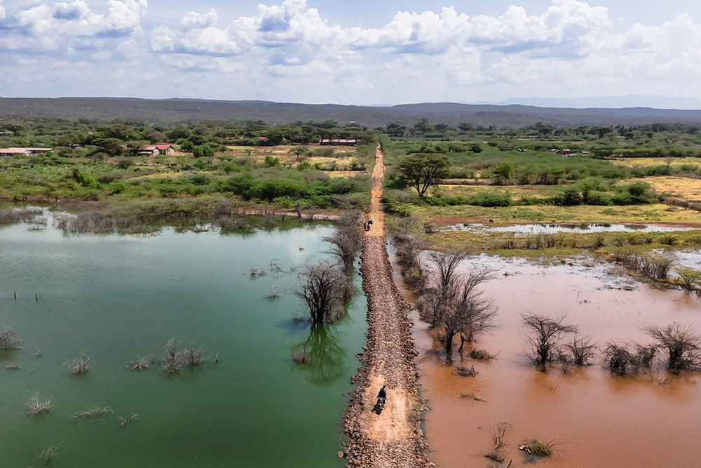An aerial image shows the caustic Lake Bogoria on the left adjacent to the freshwater Kiborgoch swamp that is fed by one of the main tributaries of neighbouring freshwater Lake Baringo, separated by a raised mound of earth serving as a crossing point over the rising waters of the lake in Marigat sub-county, Baringo county on July 29, 2026. (Photo by Tony KARUMBA / AFP)