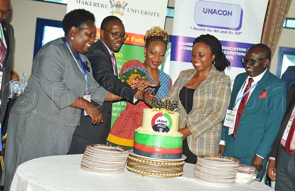 (L-R) Annet Kutesa, the Dean School of Dentistry Makerere University, Daniel Kyabayinze, the Director Public Health, Flavia Senkubuge Deputy Dean Stakeholder’s faculty of Health Science University of Pretoria, Damalie Nakanjako Principle College of Health Science with Robert Basaza of Uganda National Association of Community Occupational Health (UNACOH) cut cake after the 17th Joint annual Scientific and Health Conference held in Entebbe Uganda on 22nd September 2023. (All Photos by Godiver Asege)