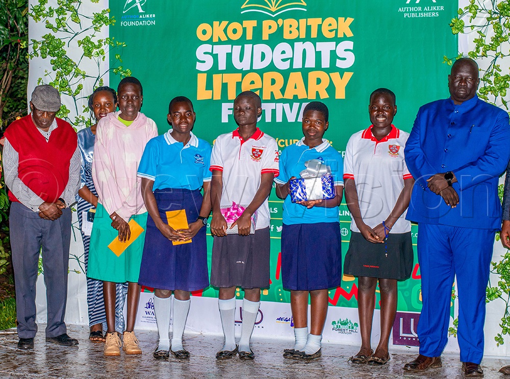 Students who won both written and spoken poetry pose for a group photo with Prof. Charles Nelson Okumu, an associate Professor of Literary and Cultural Studies in the Department of Languages and Literature, Faculty of Education and Humanities, Gulu University (Extreme left), together with RDC Amuru, Geoffrey Osborn Oceng. (Photo by Jackson Kitara)