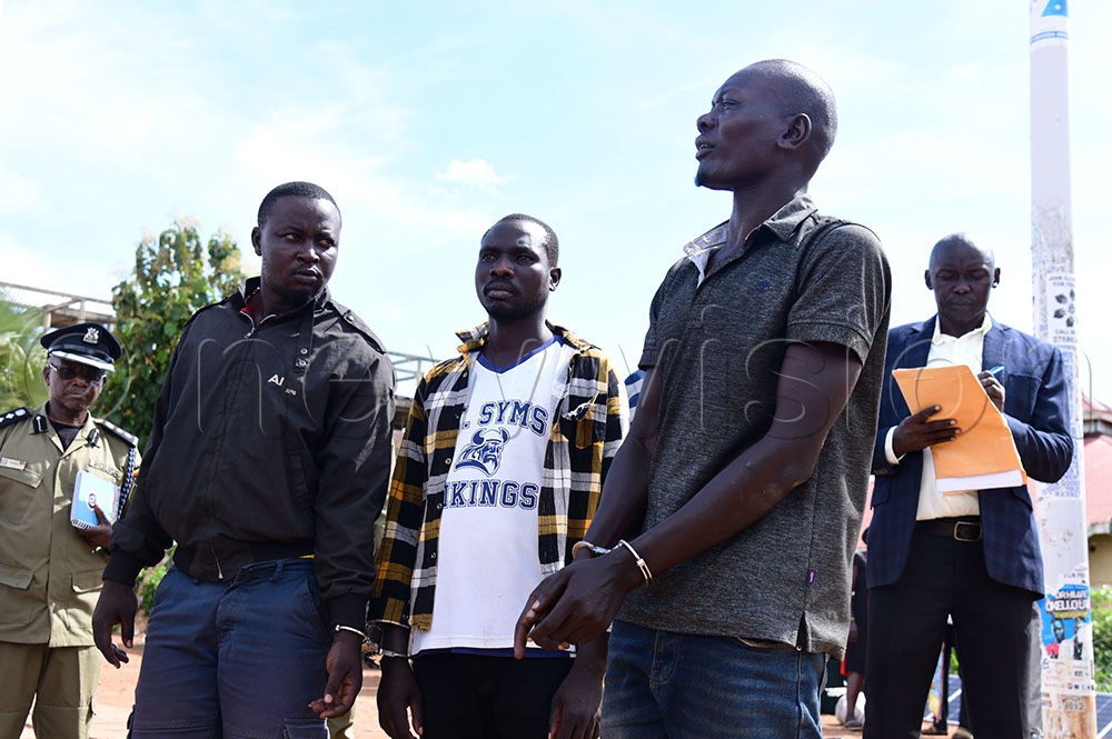 Simon Epeu alias Iboda and his co-accused on handcuffs at the crime scene. (Credit: Godfrey Ojore)