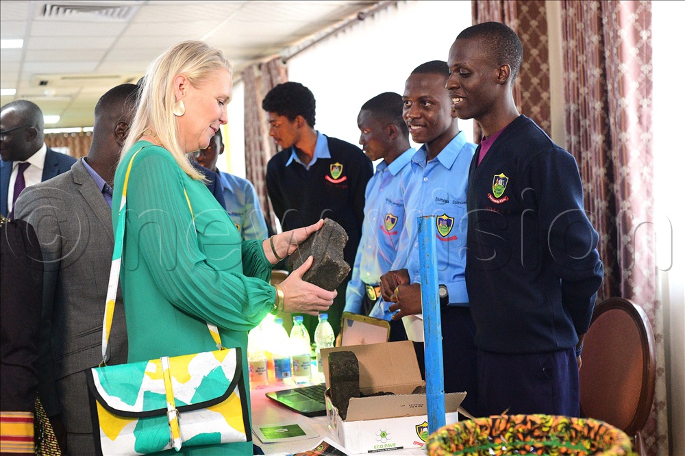 The British High Commissioner to Uganda Lisa Chesney listens to students from Kitante Hill S.S as they exhibit their pavers made from recycled plastic and sand. This was during her tour around a students&rsquo; exhibition themed sustainable waste management sponsored by the British High Commission through the Chevening Alumni Association of Uganda at Hotel Africana in Kampala on April 9, 2026.  