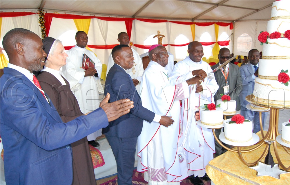 Bishop Joseph Antony Zziwa (wearing a skull-cap), Fr. Lazarus Kiggundu (third-right), Ggingo Kaberenge (left), Peter Ssentale (fourth-left) and other guests cutting cake in celebration of the 25th anniversary of Kyengeza Catholic parish on January 10, 2026.