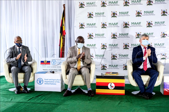 (L-R) Antonio Querido, Uganda FAO (Food and Agriculture Organisation) Country Representative, Vincent Ssempijja, Minister of Agriculture, Animal Industry and Fisheries and Alexander Polyakov, Russian Ambassador to Uganda clap during the occasion for handing over a demi cheque of 3million US dollars contribution from Russia to FAO in Uganda to help in the fight against locust in Uganda. This happened at Ministry of Agriculture, Animal Industry and Fisheries in Entebbe. (Photo by Hajarah Nalwadda)