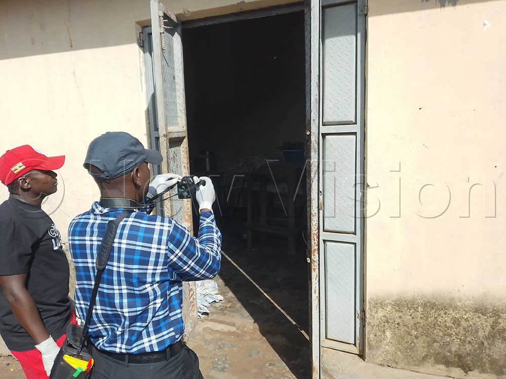 A crime scene officer recording the moments inside the restaurant where the body was lying. (Credit: Godfrey Ojore)