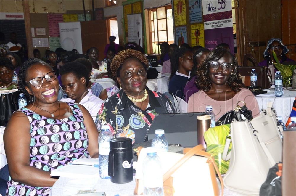 Lucy Peace Nantume (left), Chairperson Board, Susan Okalany (centre), High Court judge ,Sarah Anzoa (right), Board member interacting during the 51st Annual General Meeting (AGM) of FIDA -Uganda at Kazo Mixed Day and Boarding Primary School in Wakiso district. 