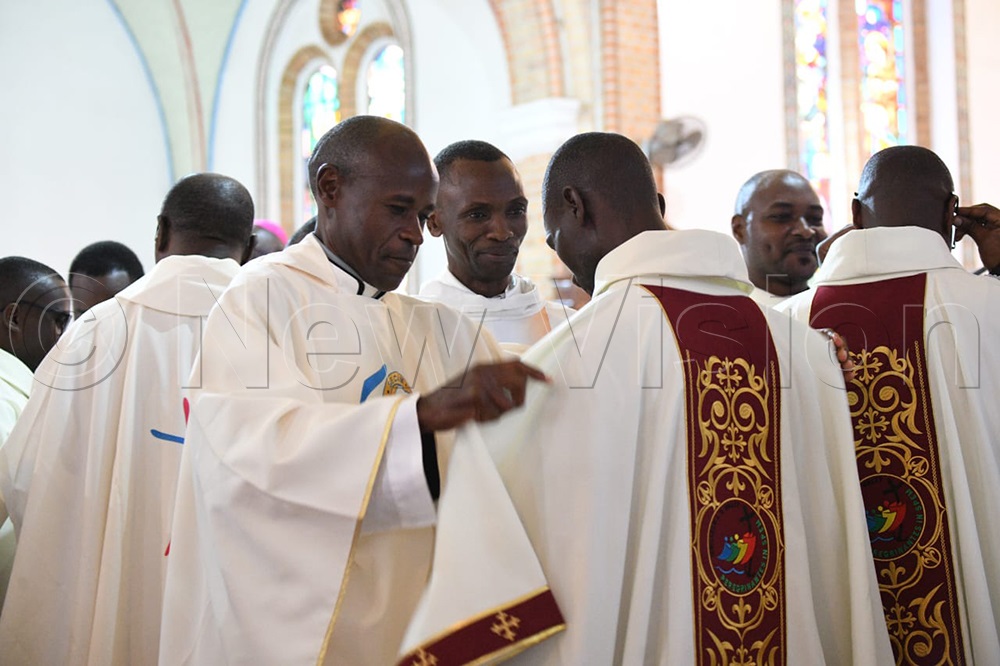 Priests are dressing up and congratulating the newly ordained priests. (Credit: Maria Wamala)