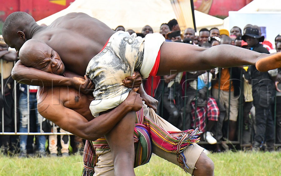 Local wrestlers competing during the 4th edition of the Ekigwo Naisoloza at Ekitudha Konta Nkonte concert in Kyabazinga Stadium .  Photo by Donald Kiirya