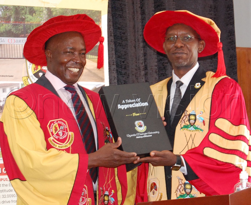 Mr Francis Kamulegeya (left) receiving a gift from the Vice-Chancellor of Uganda Martyrs University, Prof. Patrick Edrin Kyamanywa. Kamulegeya delivered the Commencement Lecture of the 32nd Graduation Ceremony of Uganda Martyrs University at the university's main campus at Nkozi, in Mpigi district on Saturday, October 17, 2026. (Photo by Mathias Mazinga)