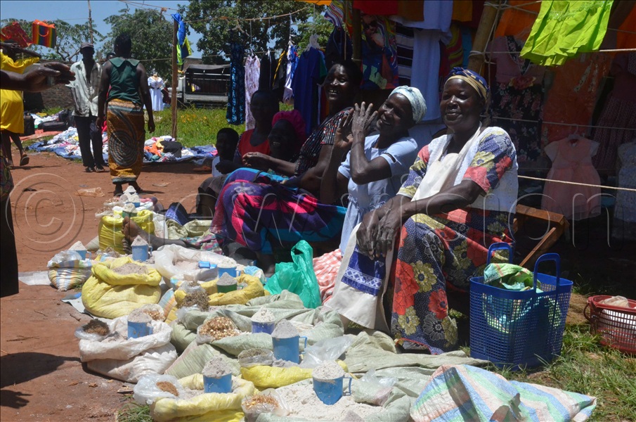 Women selling food commodities at Mit Pa Coo market in Oyam district.