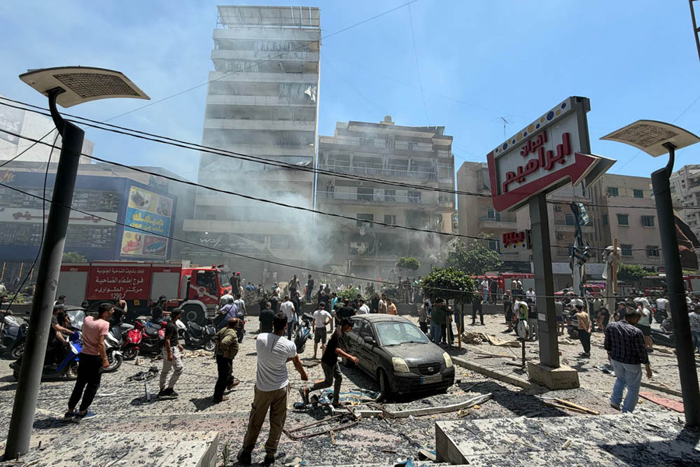 People gather at the site of an Israeli airstrike that targeted a building in Beirut’s southern suburbs on June 14, 2026.