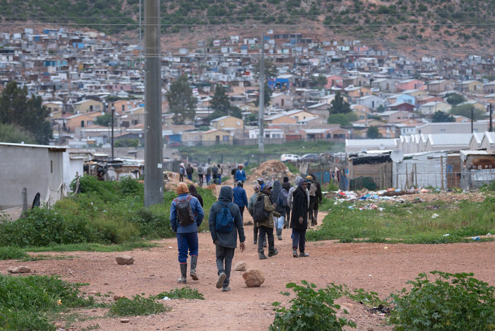 Workers, mostly from local farms return from work to Nkqubela township and informal settlement, where they live, in the town of Robertson, in the Western Cape Province, on July 9, 2026. Similar 