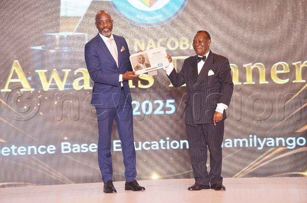 The Prime Minister of Busoga Kingdom and Executive Director National Planning Authority, Joseph Muvawala receiving an award from Amb Prof. Ssemakula Kiwanuka. (Photo by Isaac Nuwagaba)