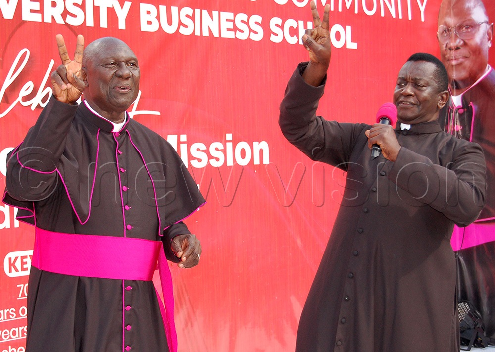  Msgr. Dr. Larry Ssemusu (left) dances as Fr. Anthony Musaala croons a Gospel song. This was during Ssemusu's 45th priestly anniversary celebration at St. Padre Pio Chapel, MUBS, Nakawa on Saturday, October 4, 2025. (Photo by Mathias Mazinga)