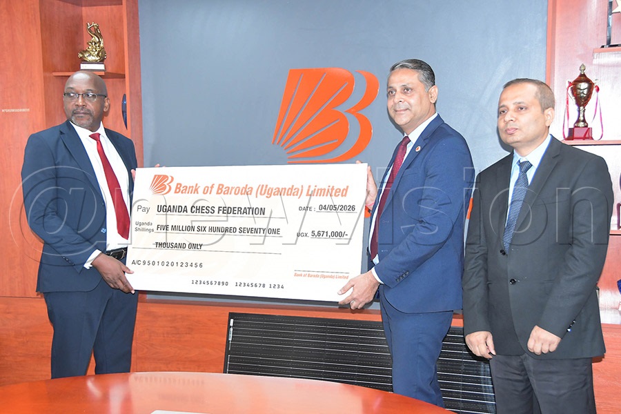 Bank of Baroda Managing Director Chandan Singh (center) and CEO Deepak Kumar handing over a dummy cheque and solar panel to Uganda Chess Federation president Andrew Bakiza at their office on Kampala Road, May 4, 2026. (Photo: Silvano Kibuuka)