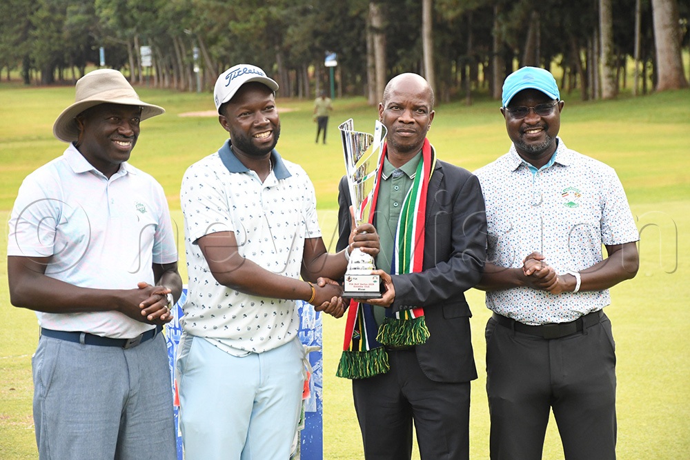 Ronald Rugumayo (2nd left) receives the winners' trophy from Silence Zondi Makhubele (High Commissioner-designate of South Africa) as POA chairman Edward Nyatia (left) and UGU president Jackson Were look on at the Entebbe Club course, September 19, 2026. (Photo by Michael Nsubuga)