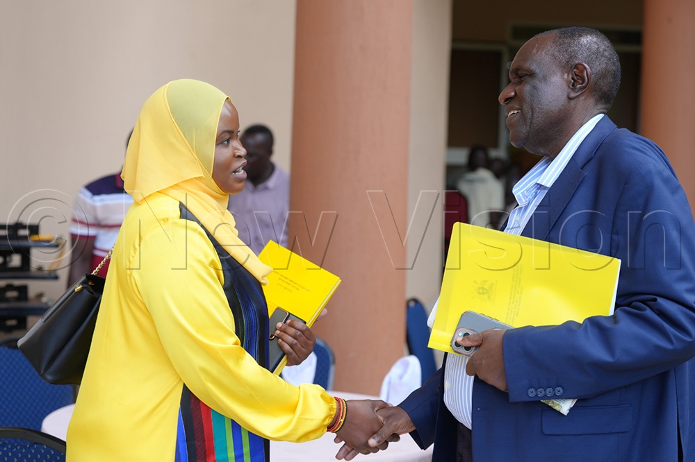 Asha Nabulo Lumolo Mafabi in discussion with Yunus Kakande in Mbale City on plans for a tomato processing plant in Sironko. (Photo By Javier Silas Omagor)