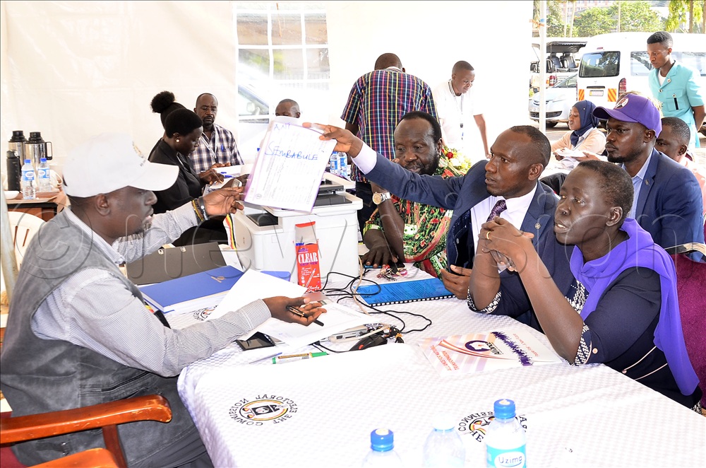 The Electoral Commission officer, James Magarura (left) receive files contains the signatures submitted by a team from Alliance for National Transformation party lead by Alice Alaso (right) during the submission of signatures by the presidential candidates at Electoral Commission offices Kampala on 17 September, 2025.