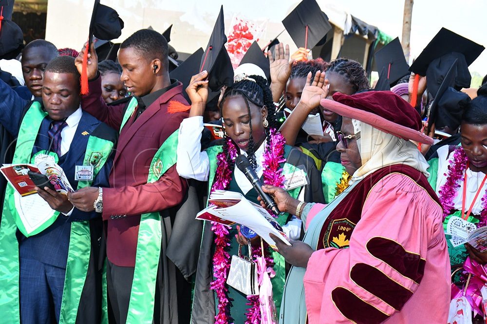 Some of the graduates taking their oath as they were assisted by Hajati Safina Museene (R) the Commissioner of Health Education and Training at the Ministry of Education and Sports. (Photo by Donald Kiirya)